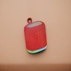 The portable, waterproof and 360-degree surround sound Bluetooth speaker with a red fabric shell details Picture
